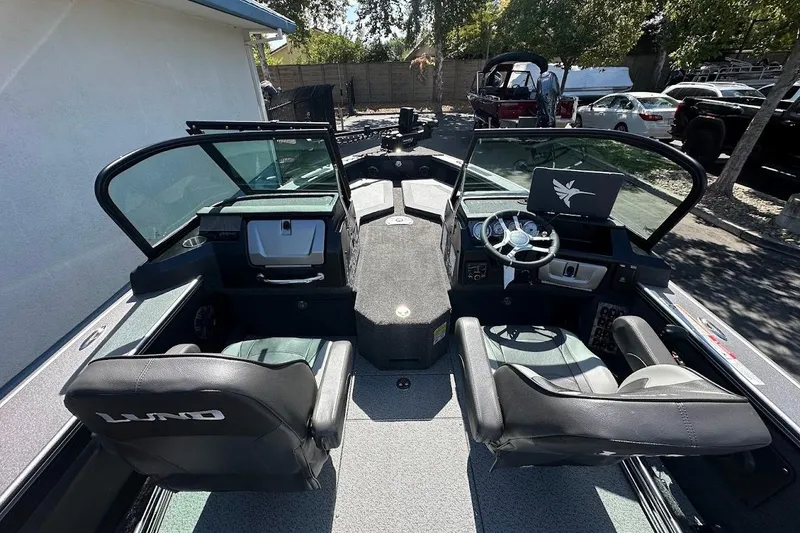 Slide: The Image of 2025 Lund 1875 Pro-V boat interior with dual seats and modern dashboard. - 15