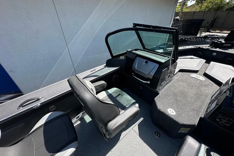 Slide: The Image of 2025 Lund 1875 Pro-V boat interior with seating and dashboard, showcasing modern design. - 16