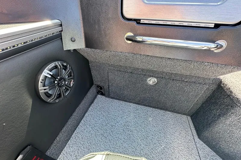 Slide: The Image of Interior of 2025 Lund 1875 Pro-V boat featuring speaker and storage compartment. - 19