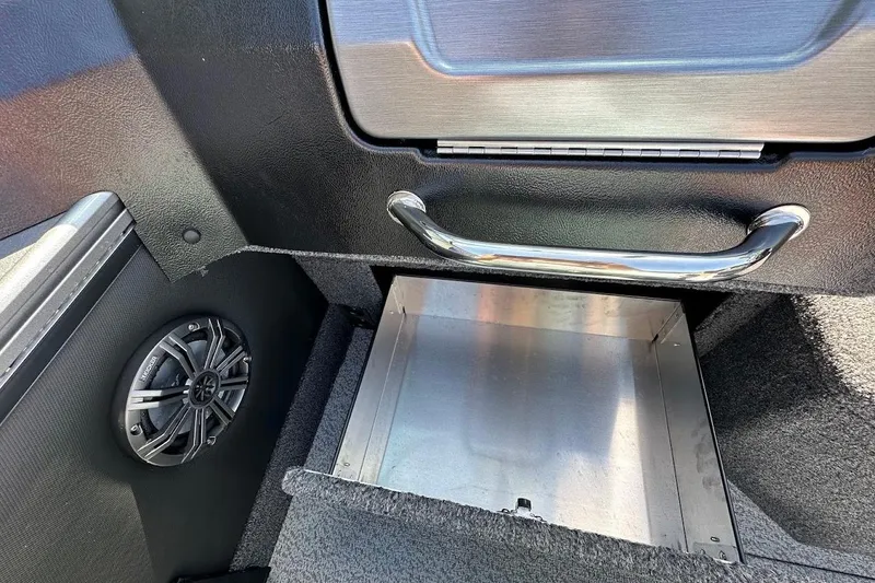 Slide: The Image of 2025 Lund 1875 Pro-V boat interior with speaker and storage compartment. - 20