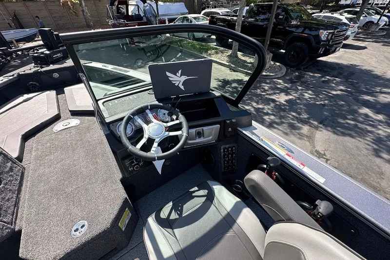 Slide: The Image of 2025 Lund 1875 Pro-V boat interior with steering wheel and dashboard display. - 22