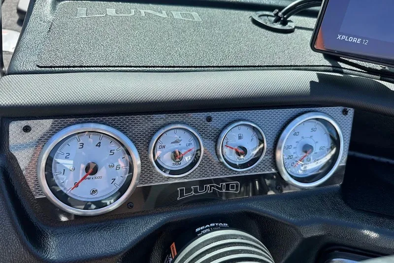 Slide: The Image of Dashboard of 2025 Lund 1875 Pro-V boat with gauges and Xplore 12 display. - 25