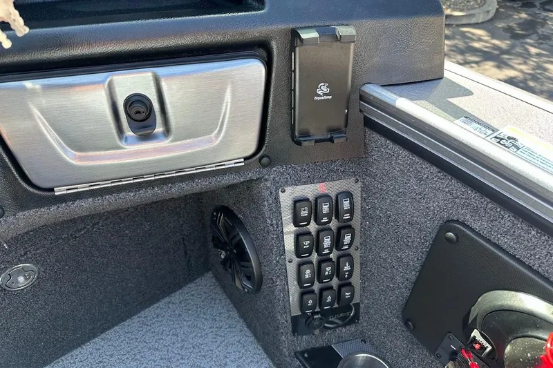 Slide: The Image of Interior view of 2025 Lund 1875 Pro-V boat dashboard with control panel and speaker. - 27