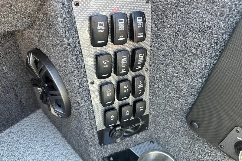 Slide: The Image of Control panel of 2025 Lund 1875 Pro-V boat with switches and speaker. - 28