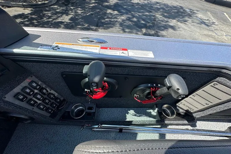 Slide: The Image of Control panel of 2025 Lund 1875 Pro-V boat with throttle and switches. - 30