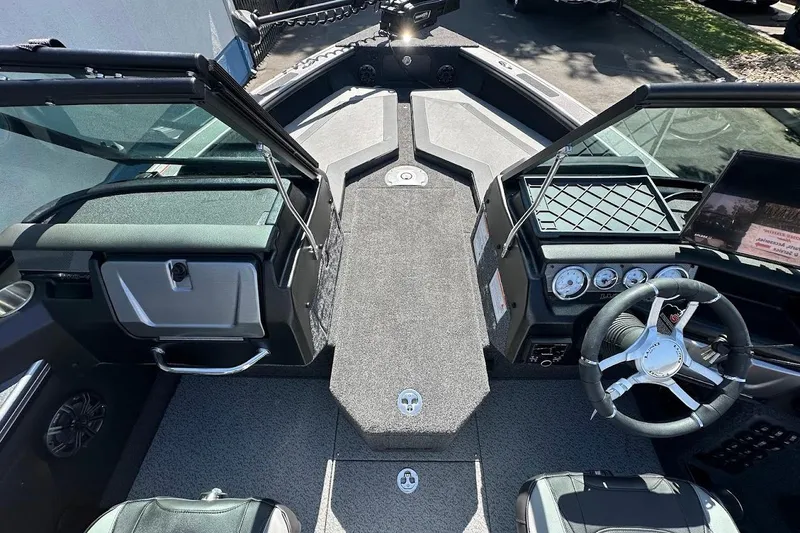 Slide: The Image of 2025 Lund 1875 Pro-V boat interior with modern dashboard and steering wheel. - 31