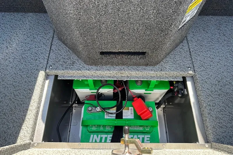 Slide: The Image of 2025 Lund 1875 Pro-V boat battery compartment with Interstate batteries visible. - 35