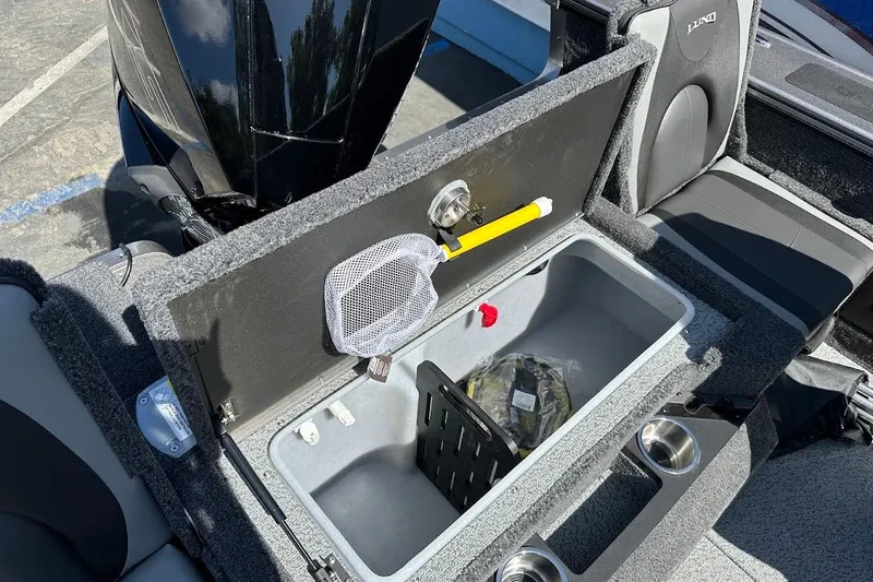 Slide: The Image of 2025 Lund 1875 Pro-V boat storage compartment with open lid and accessories. - 43