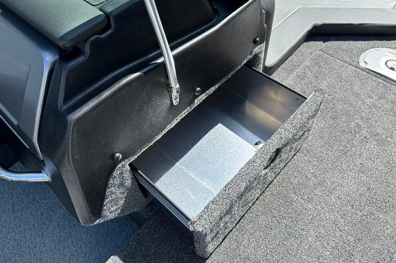 Slide: The Image of 2025 Lund 1875 Pro-V boat storage compartment with open drawer, showcasing interior space. - 45