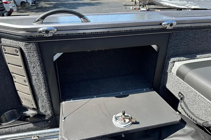 Slide: The Image of 2025 Lund 1875 Pro-V boat storage compartment with open hatch and secure latch. - 47