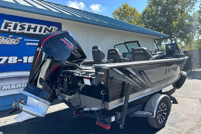 Slide: The Image of 2025 Lund 1875 Pro-V boat with Mercury Pro XS engine, parked outdoors. - 7