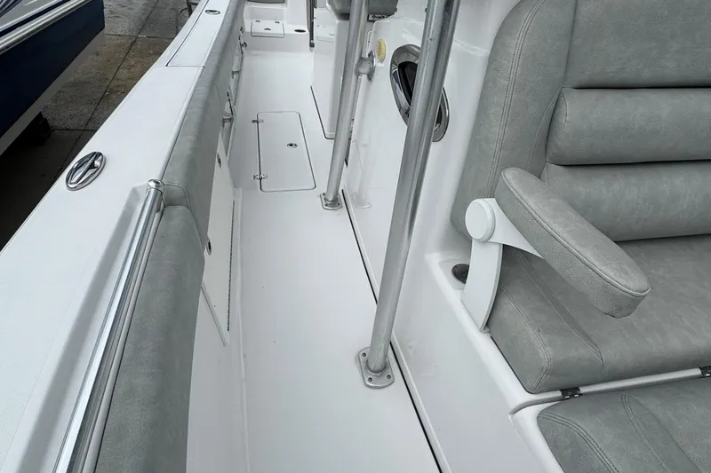 Slide: The Image of 2020 Sportsman Open 282TE Center Console interior with gray seating and white deck. - 13