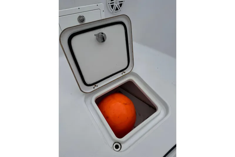 Slide: The Image of Open storage compartment on 2020 Sportsman Open 282TE Center Console boat. - 17
