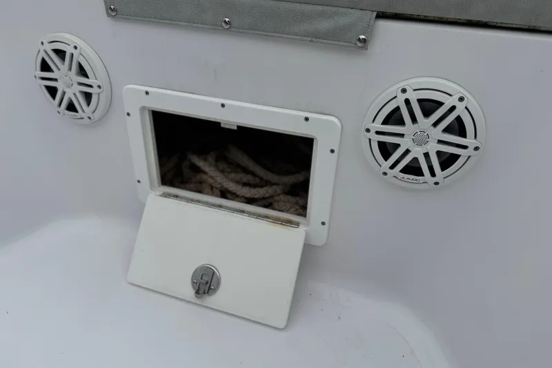 Slide: The Image of 2020 Sportsman Open 282TE Center Console with speakers and rope storage compartment. - 18