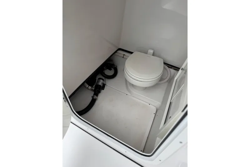 Slide: The Image of 2020 Sportsman Open 282TE Center Console boat interior with marine toilet. - 19