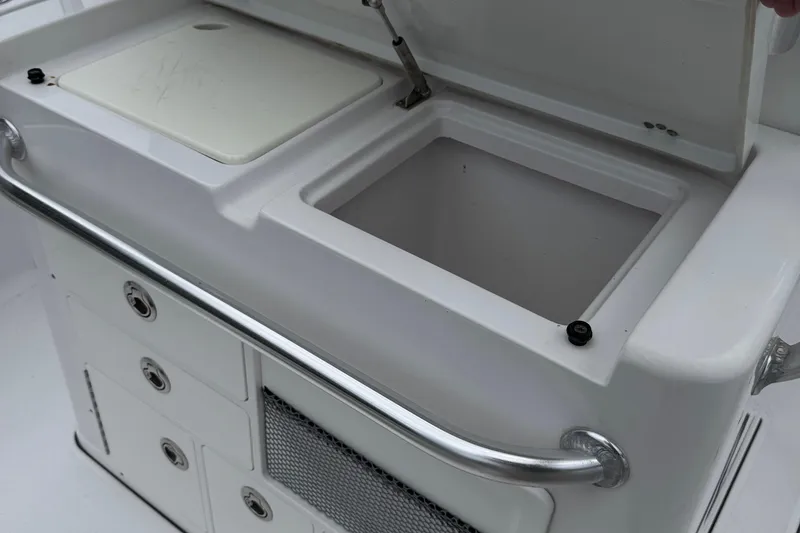 Slide: The Image of 2020 Sportsman Open 282TE Center Console storage compartment with open lid and drawers. - 22