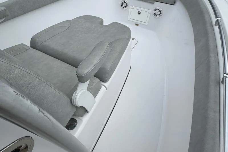 Slide: The Image of 2020 Sportsman Open 282TE Center Console boat interior with gray seating and speakers. - 7