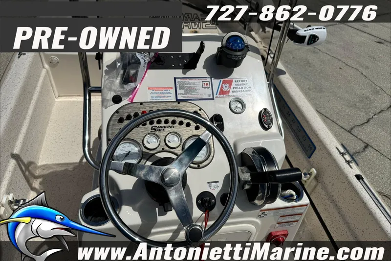 Slide: The Image of Pre-owned 2019 Carolina Skiff 18 JVX CC boat dashboard with steering wheel and gauges. - 16