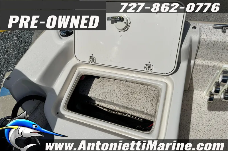 Slide: The Image of Pre-owned 2019 Carolina Skiff 18 JVX CC boat storage compartment, Antonietti Marine contact details. - 22