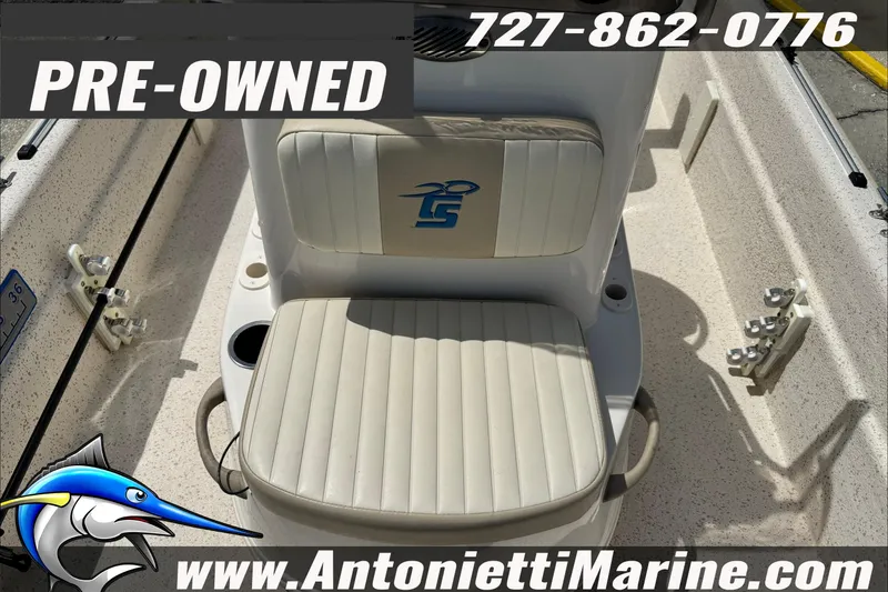 Slide: The Image of Pre-owned 2019 Carolina Skiff 18 JVX CC boat interior with seating, contact details, and website. - 27