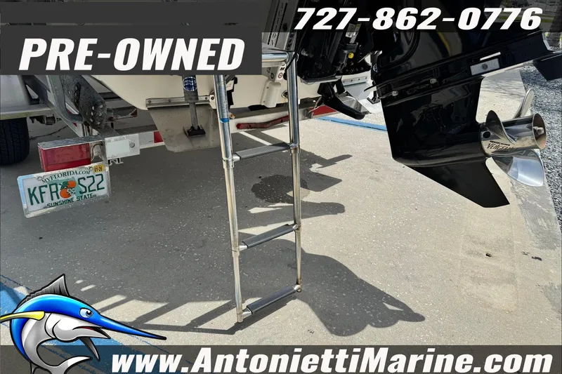 Slide: The Image of Pre-owned 2019 Carolina Skiff 18 JVX CC boat with ladder and contact details. - 9