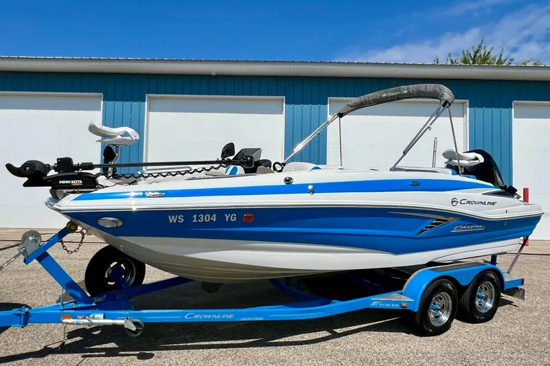 Slide: The Image of 2020 Crownline Eclipse E205 XS Fish boat on trailer, blue and white design. - 10