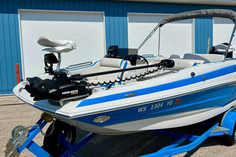 Slide: The Image of 2020 Crownline Eclipse E205 XS Fish boat with Minn Kota motor, blue and white design. - 12