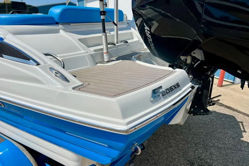 Slide: The Image of 2020 Crownline Eclipse E205 XS Fish boat with blue and white design, rear view. - 17