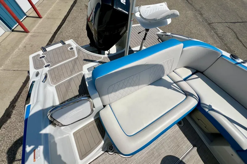 Slide: The Image of 2020 Crownline Eclipse E205 XS Fish boat interior with seating and motor. - 19