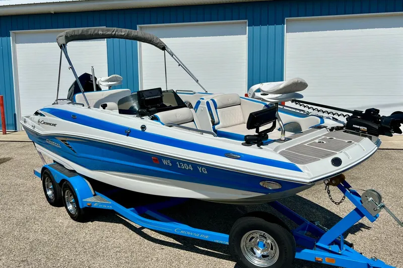 Slide: The Image of 2020 Crownline Eclipse E205 XS Fish boat on trailer, blue and white design. - 5