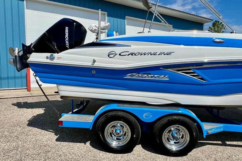 Slide: The Image of 2020 Crownline Eclipse E205 XS Fish boat on trailer, blue and white design. - 8