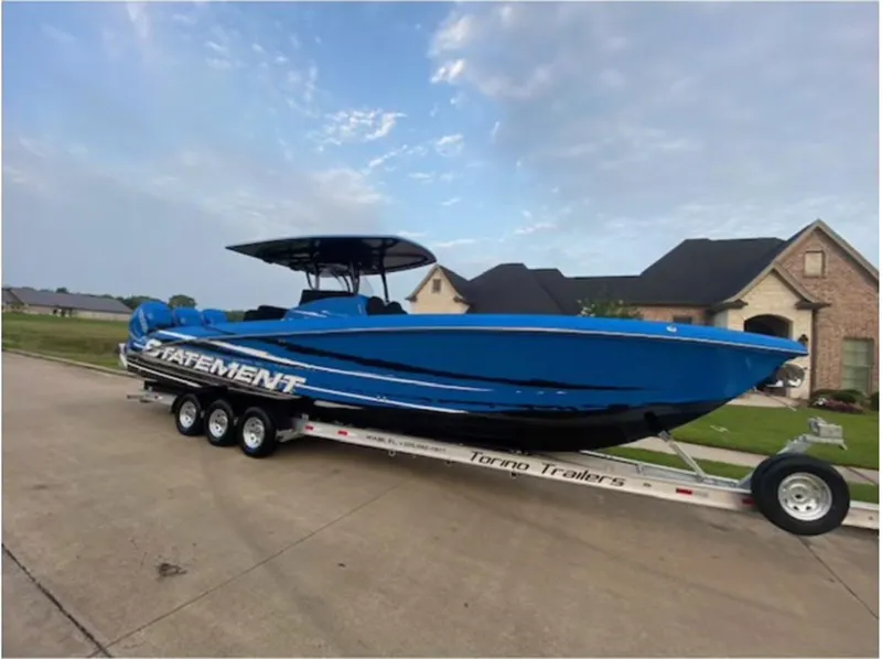Slide: The Image of Blue 2021 Statement 380 Open boat on trailer in suburban neighborhood. - 2