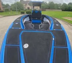 Slide: The Image of 2021 Statement 380 Open boat with sleek black and blue design on a residential street. - 5