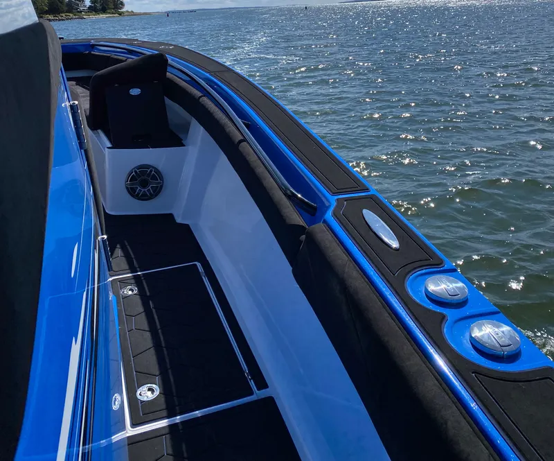 Slide: The Image of 2021 Statement 380 Open boat on water, featuring sleek blue and black design. - 7