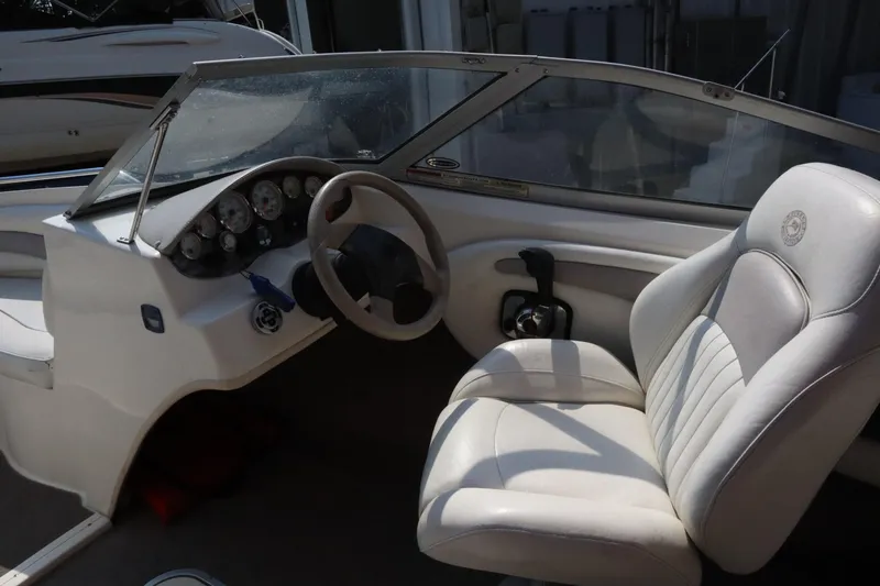 Slide: The Image of 2008 Stingray 195 LS/LX/LR boat interior with steering wheel and white seating. - 10