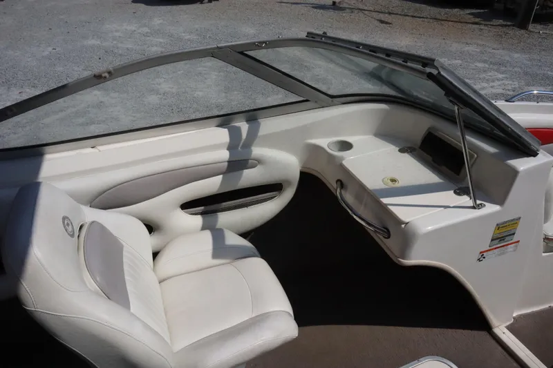 Slide: The Image of 2008 Stingray 195 LS/LX/LR boat interior with white seating and dashboard. - 11