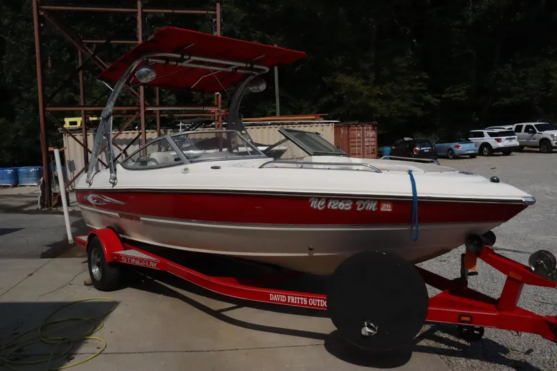 Slide: The Image of 2008 Stingray 195 LS/LX/LR boat on red trailer, parked outdoors. - 4
