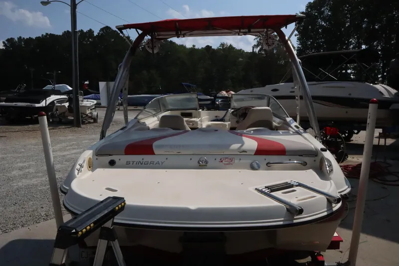 Slide: The Image of 2008 Stingray 195 LS/LX/LR boat with red canopy in a marina setting. - 5