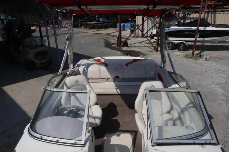 Slide: The Image of 2008 Stingray 195 LS/LX/LR boat interior with white seating and red accents. - 8