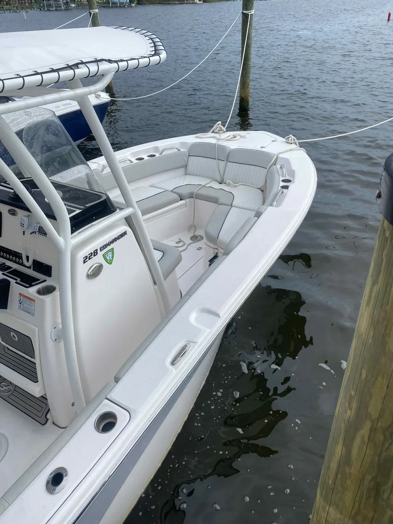 Slide: The Image of 2023 Sea Fox 228 Commander boat interior with helm, seating, and controls at dock. - 11