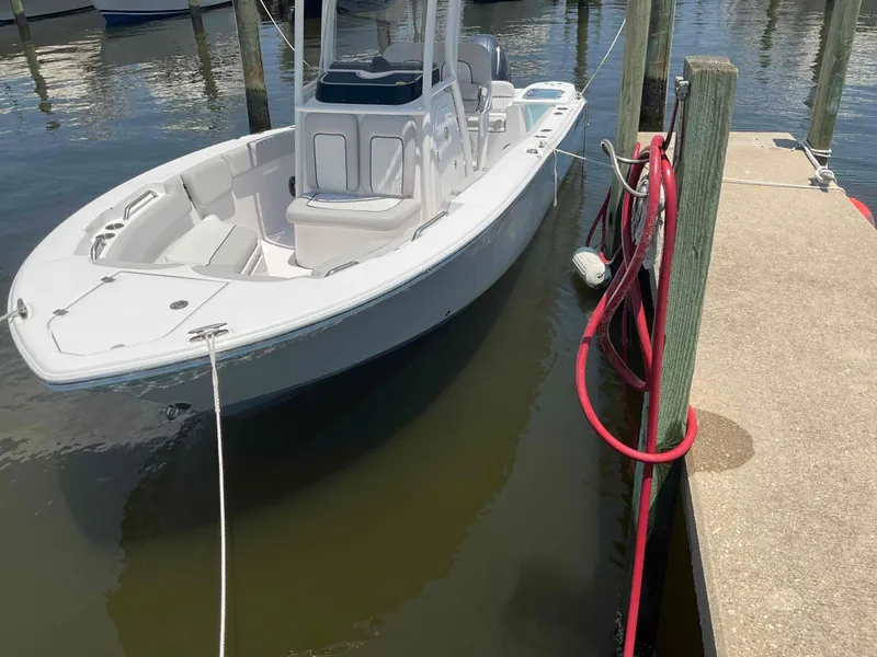Slide: The Image of 2023 Sea Fox 228 Commander boat docked on calm water. - 12