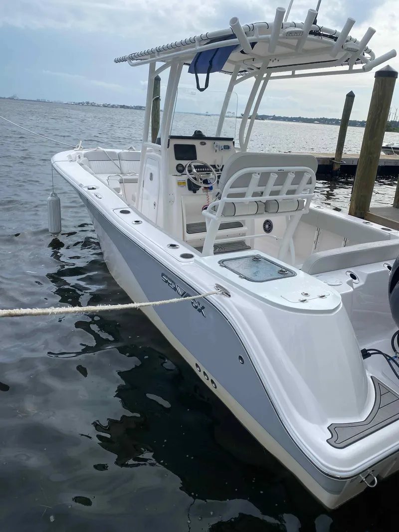 Slide: The Image of 2023 Sea Fox 228 Commander boat docked at marina under clear sky. - 16