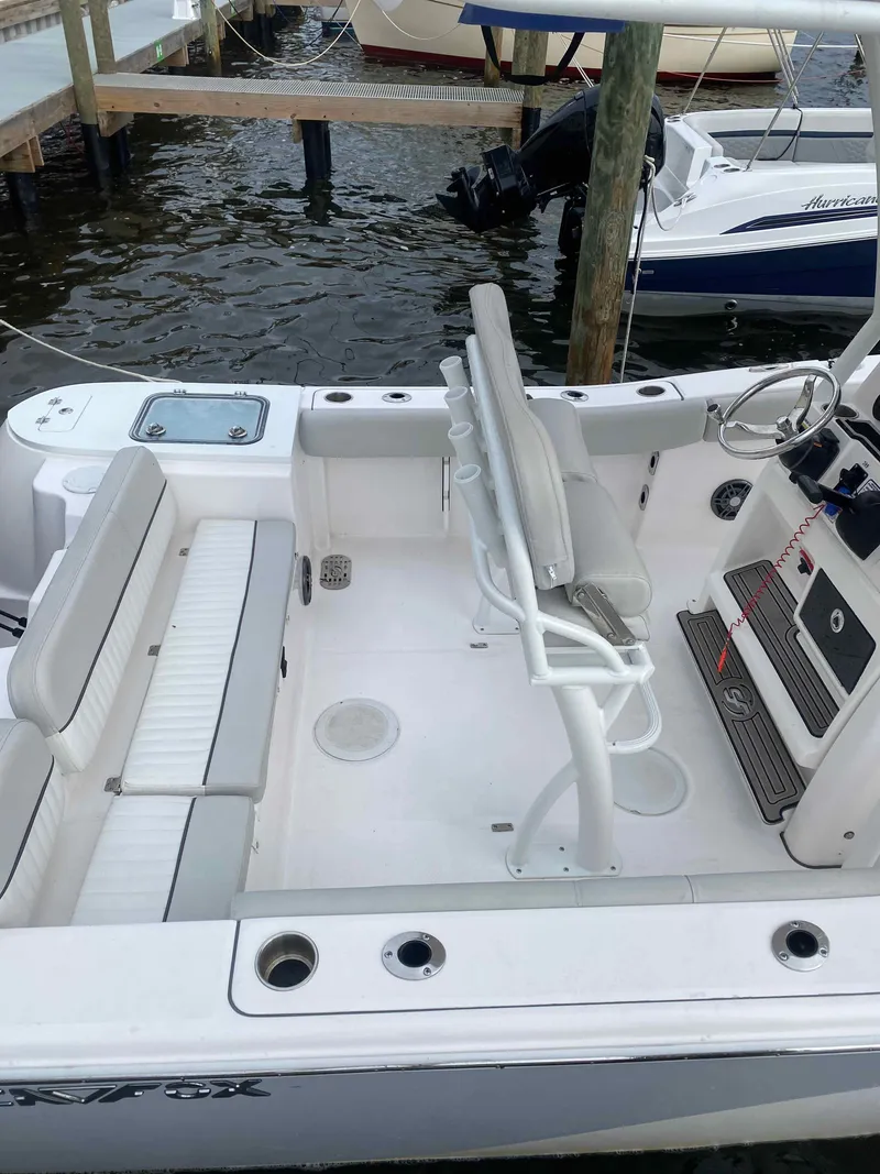 Slide: The Image of 2023 Sea Fox 228 Commander boat docked at marina with red hose. - 20