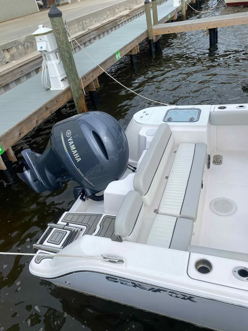 Slide: The Image of 2023 Sea Fox 228 Commander boat with sleek design and modern console at dock. - 21