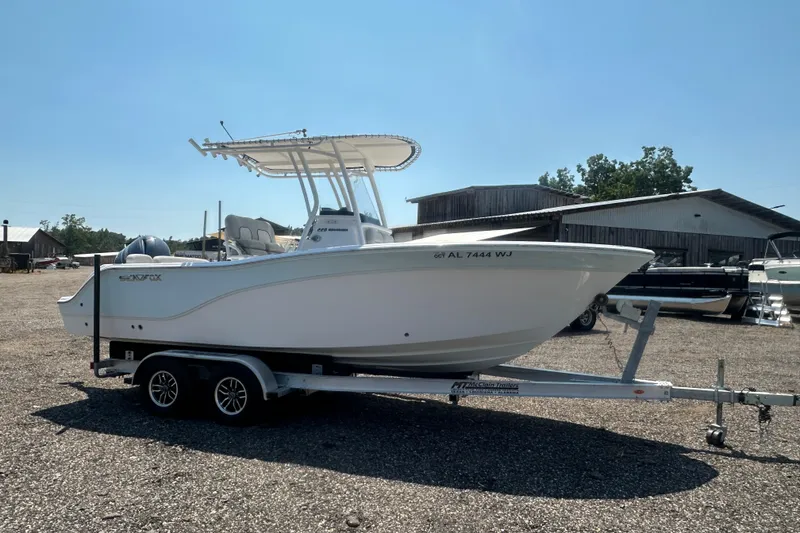 Slide: The Image of 2023 Sea Fox 228 Commander boat with Yamaha engine docked by the water. - 29