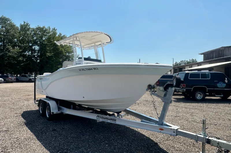 Slide: The Image of 2023 Sea Fox 228 Commander boat deck with safety warning label and stainless steel railing. - 30