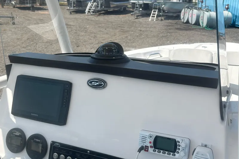 Slide: The Image of 2023 Sea Fox 228 Commander boat canopy under bright sunlight in a marina setting. - 54