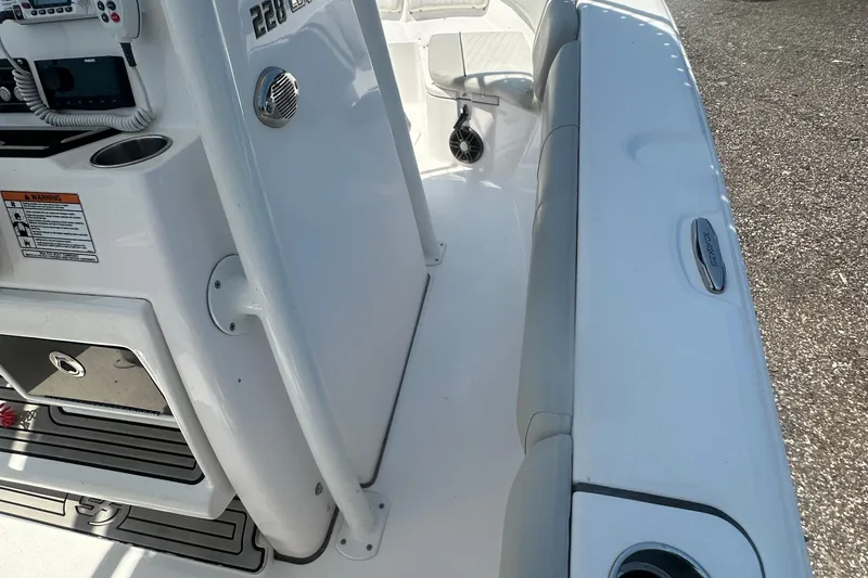 Slide: The Image of 2023 Sea Fox 228 Commander boat interior with cushioned seating and cup holders. - 56