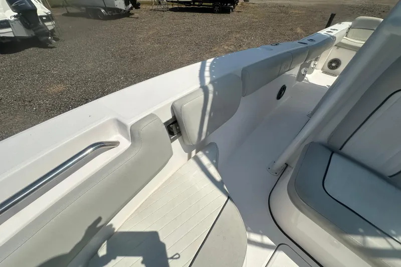 Slide: The Image of 2023 Sea Fox 228 Commander boat interior with cushioned seating and stainless steel handle. - 58