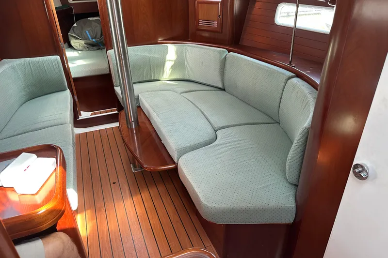 Slide: The Image of Interior of 2004 Beneteau 361 yacht with elegant wood finish and cozy seating area. - 19